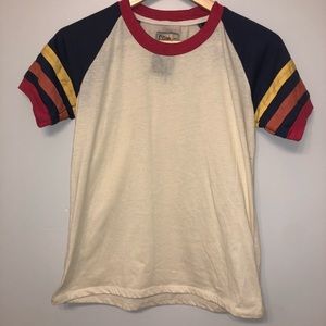 Light yellow t-shirt with colorful sleeves